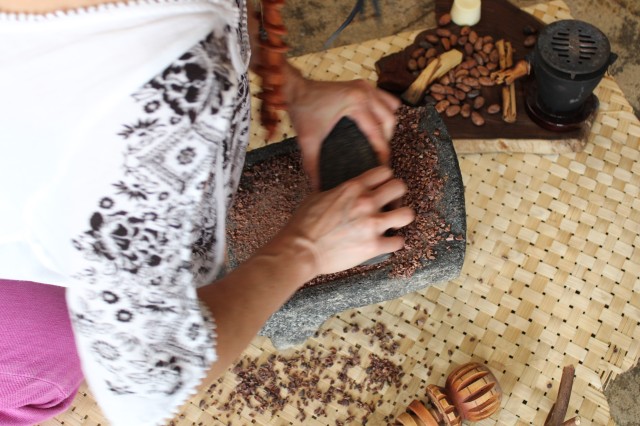 woman grinds chocolate nibs