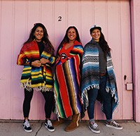 Courage Camps founders standing together wrapped in Mexican blankets (resized for website)