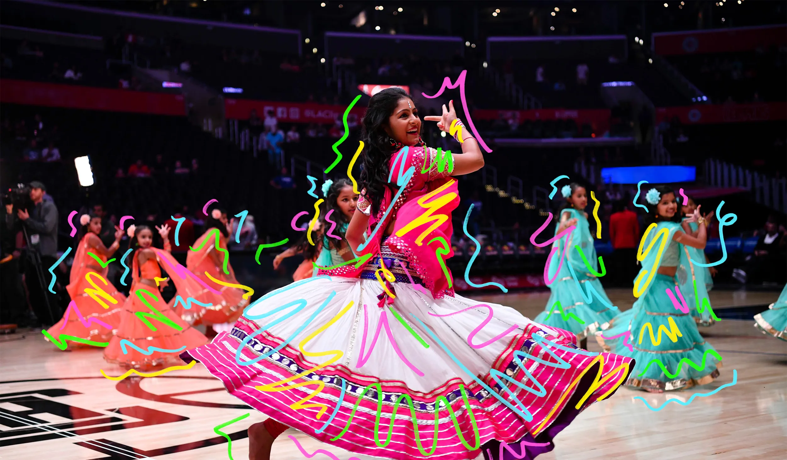 Swirls atop a woman and children dancing in colorful skirts