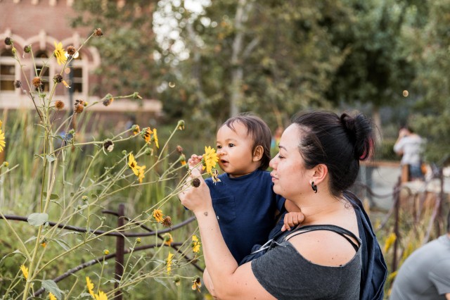 mother and child with flowers in nature gardens