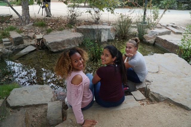 SciGirls rest by the Nature Gardens pond at NHM
