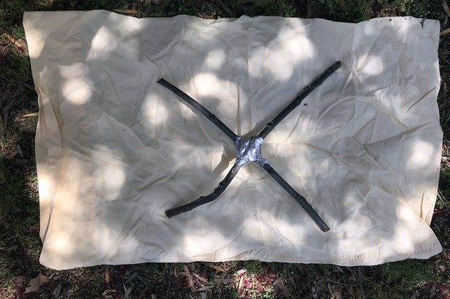 Sticks placed on top of fabric in an X shape