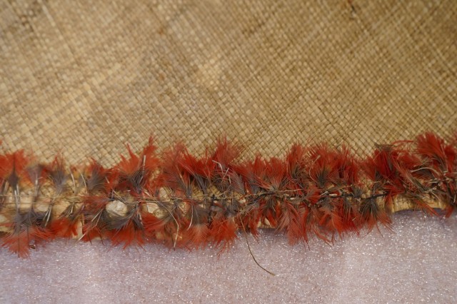 Detail view of decorative feathers on woven mat