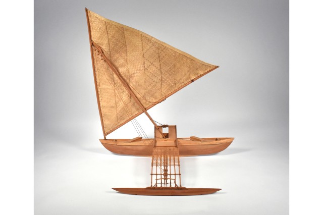 Outrigger canoe with woven mats as sails