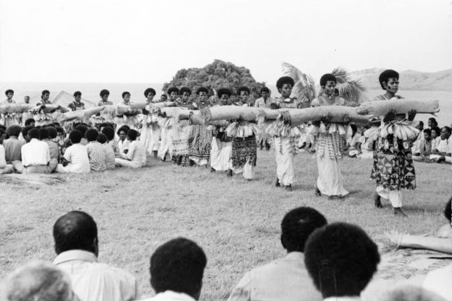 Procession of women wearing masi presenting Fijian mats and tapa cloths
