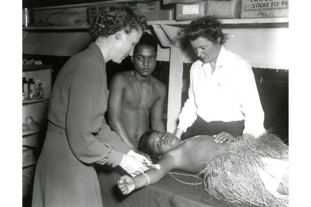 Navy nurses give a yaws injection to a Micronesian child