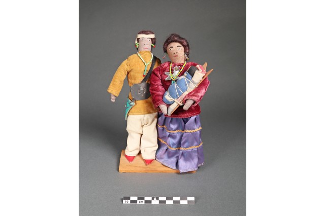 pair of dolls featuring a Navajo couple with a baby in a traditional carrier 