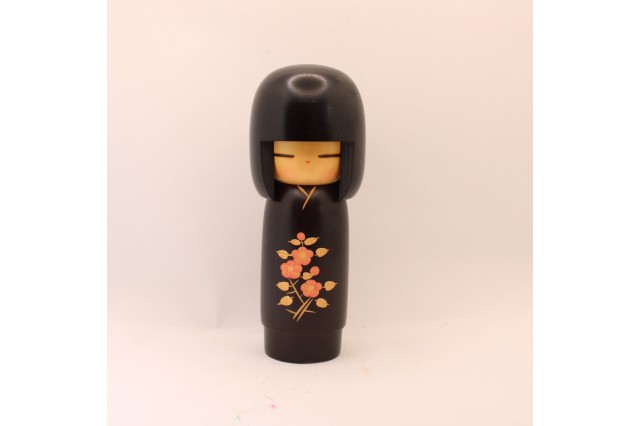 a small wooden Japanese doll 
