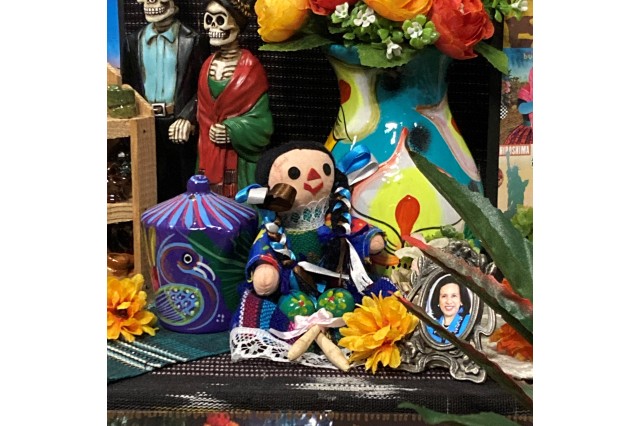 a colorful Mexican ragdoll sits in the Esparza&#039;s altar