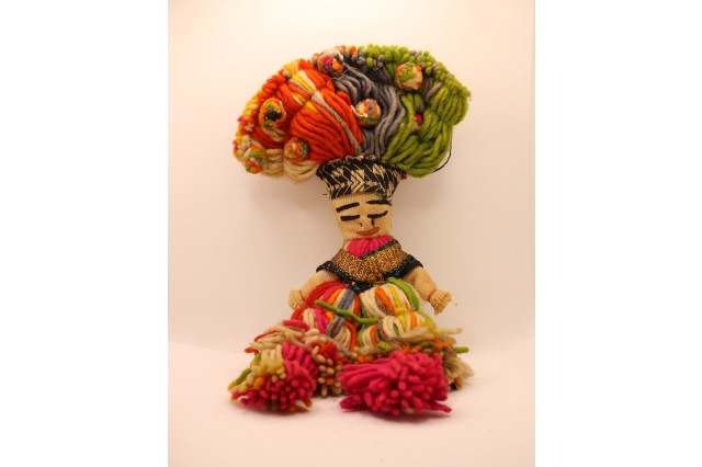 hand made doll made with colorful yarn and fabric 