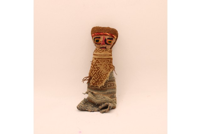 a small doll made of cloth representing a Peruvian person