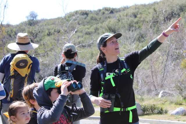 Ornithology Curator Allison Shultz pointing something out to a group of hikers