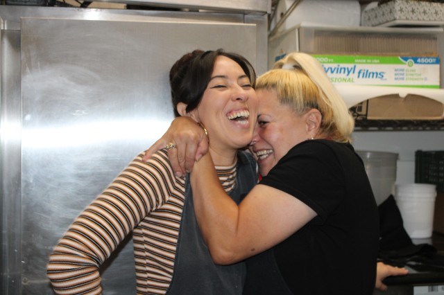 Two women hugging and laughing
