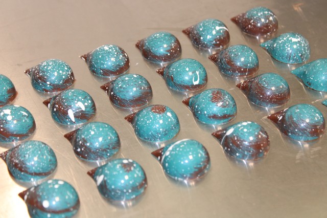 Turquoise and brown tear-drop shaped chocolates shot from above