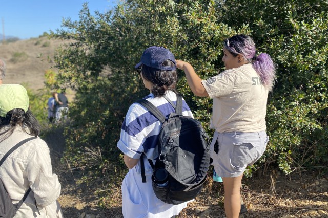 NHM Community Science Coordinator Valerie Ahumada points out local wildlife