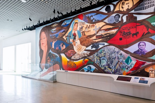 Multi-colored mural made up of many vignettes, installed on the wall