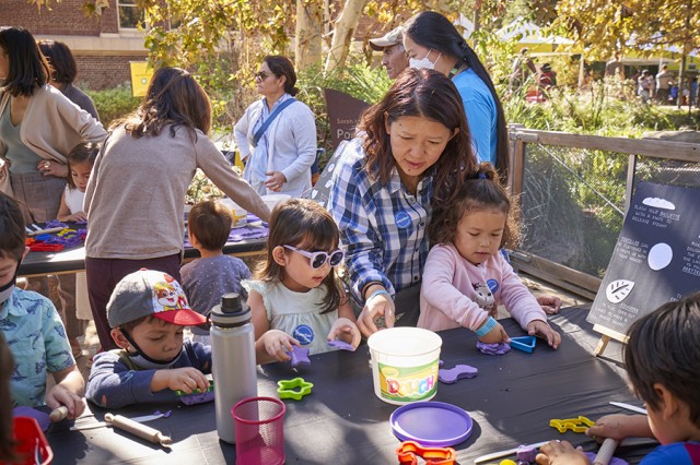 Children working with cookie cutters around a table