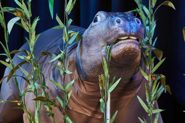 shiny brown and pink hippo-like puppet surrounded by sea kelp