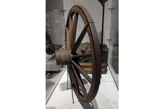 Side view of wooden spoked wagon wheel, three feet in diameter