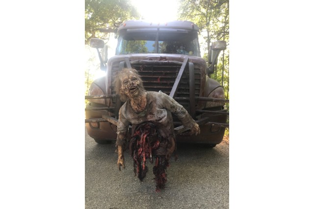 Kanya as a zombie missing her legs on a truck