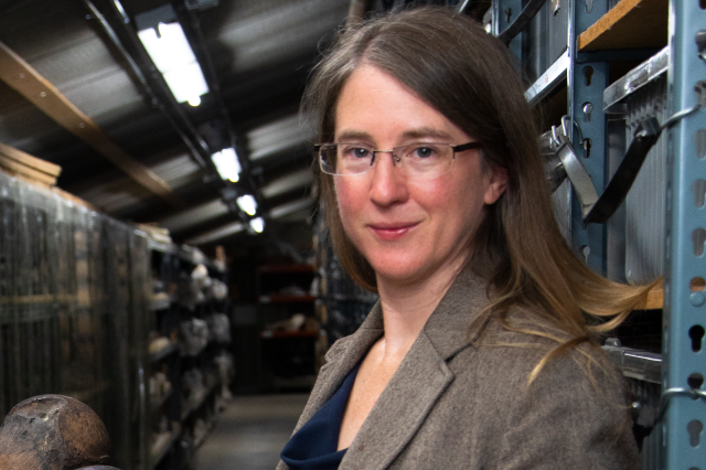 Emily Lindsey in a store room with shelves behind her