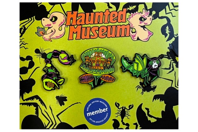 Haunted Museum in orange letters between cartoon ghosts, above three green, orange, and purple pins