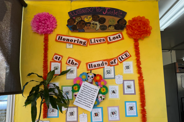 A close-up of a memorial wall inside Cruzita's Deli featuring photos, names, and candles dedicated to individuals who lost their lives due to ICE enforcement, reflecting the business's community activism.