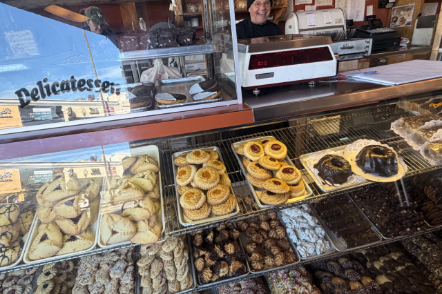 Bakery display counter with traditional Jewish patsries.