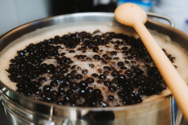 Boba balls inside of pot with foamy top