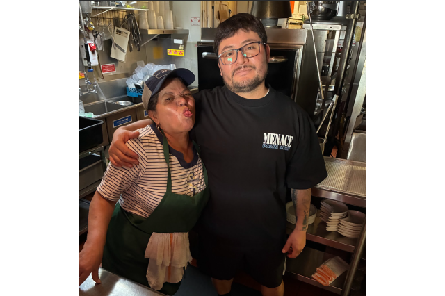  A photograph of The Ruby Fruit team members Regina (left) and Froilan (right) standing together. 