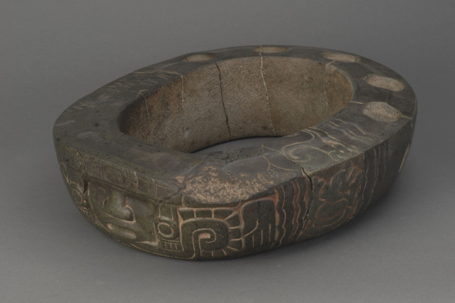 Stone yolk with carved decorations used in the Mesoamerican ball game.
