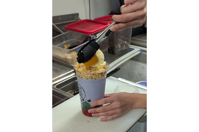 Flan and ice cream toppings added to a colorful hallo-halo drink.