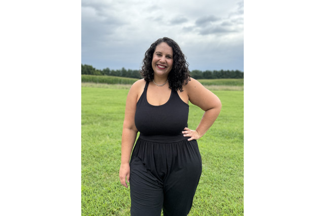 Dr. Gaila Sims wearing black, with hand on hip