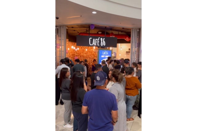 A long line of people waiting outside the grand opening of Cafe 86 in Glendale Mall.