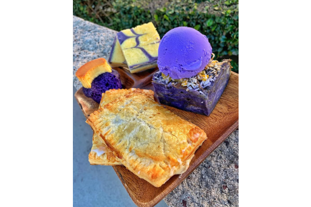 Plate of assorted ube-flavored pastries in purple and yellow colors.