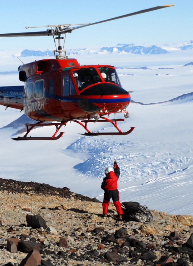 helicopter flying over person in antarctica