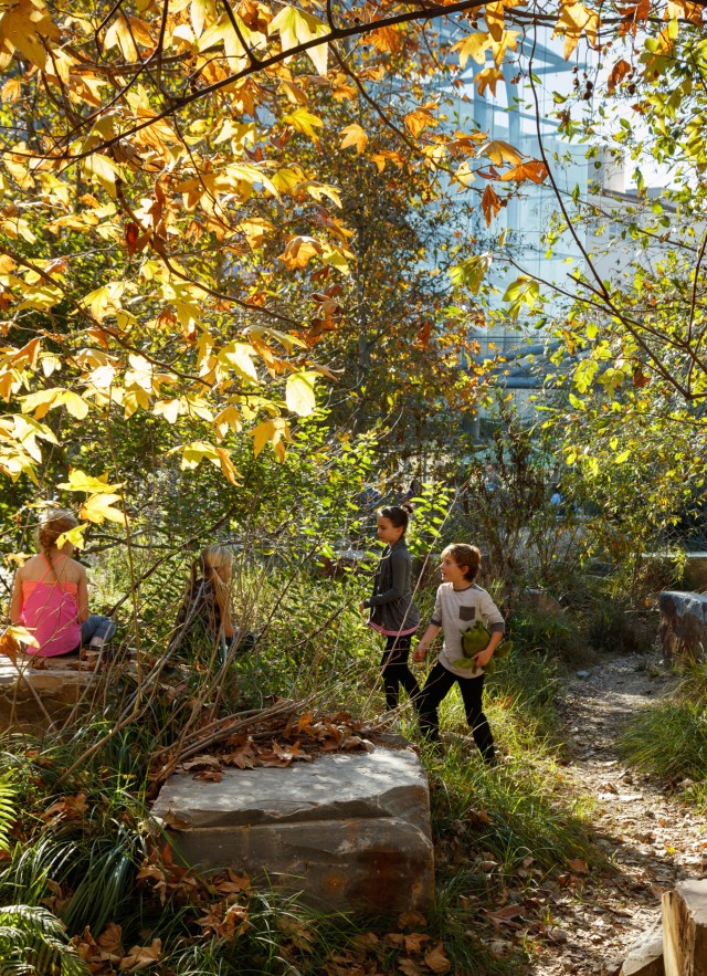 kids in the dry creek bed in the nature gardens