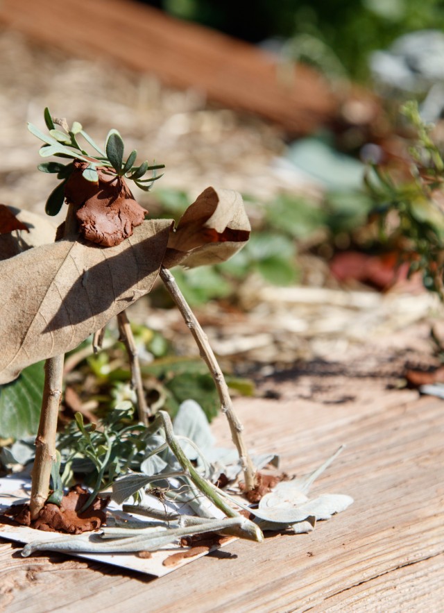 Small structure made from sticks, leaves, and clay created by students as homes for bugs