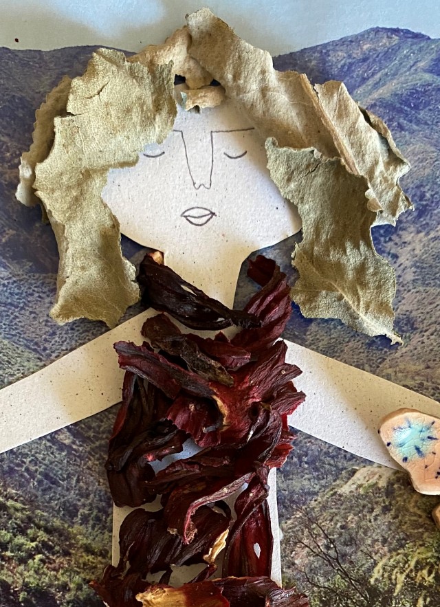 Paper doll decorated with natural materials