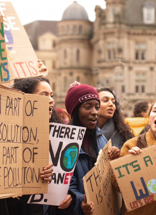 Image of youth advocates holding protesting signs