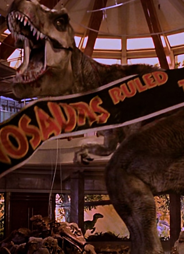 Orange and black banner in front of a dinosaur