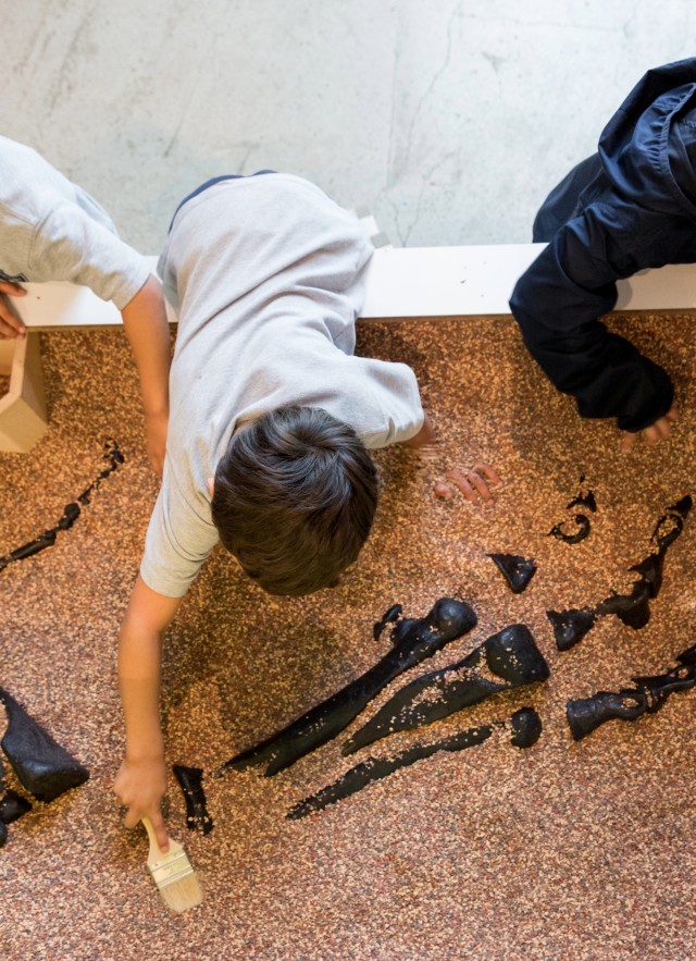 Students excavating in Discovery Center