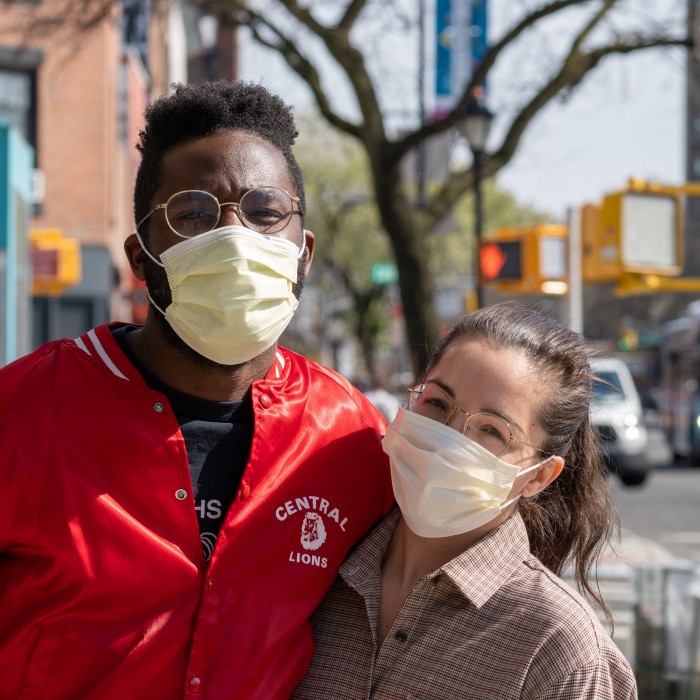 young couple outside wearing face masks