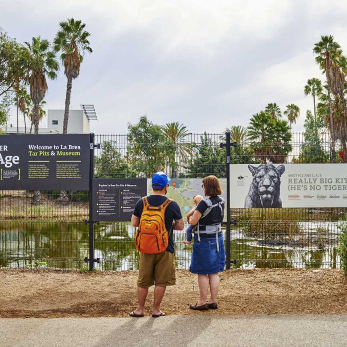 family standing in front of lake pit at la brea tar pits