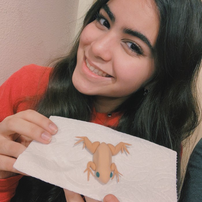 Kiana poses with her model frog