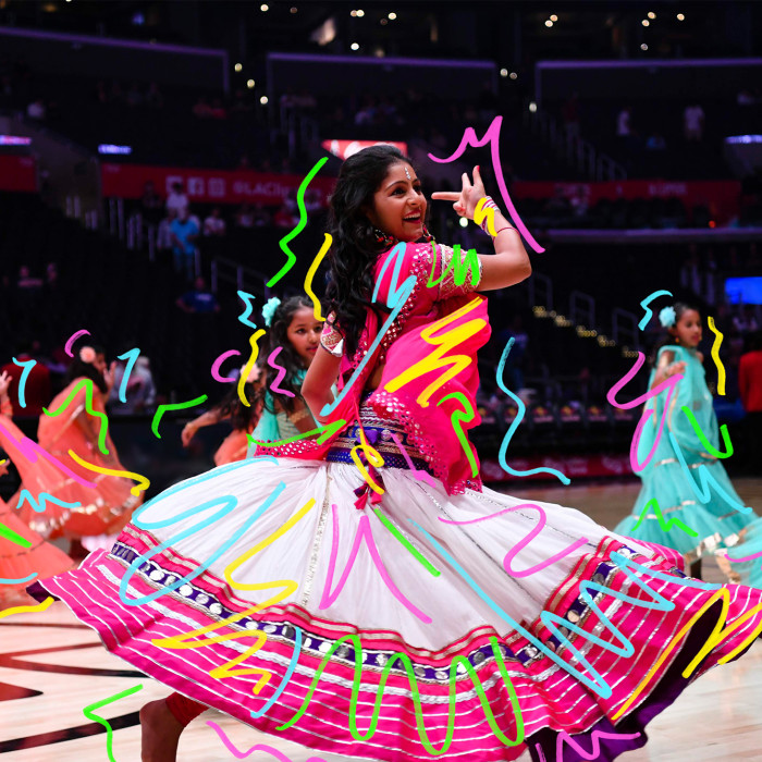Swirls atop a woman and children dancing in colorful skirts