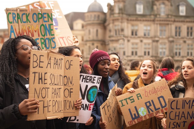 Image of youth advocates holding protesting signs