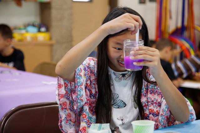 child playing with purple slime