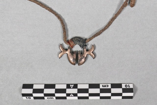 amulet with natural fiber strung through