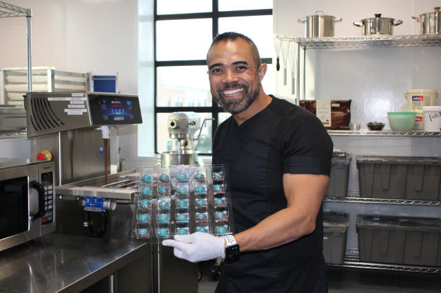 Man holding tray of chocolates 